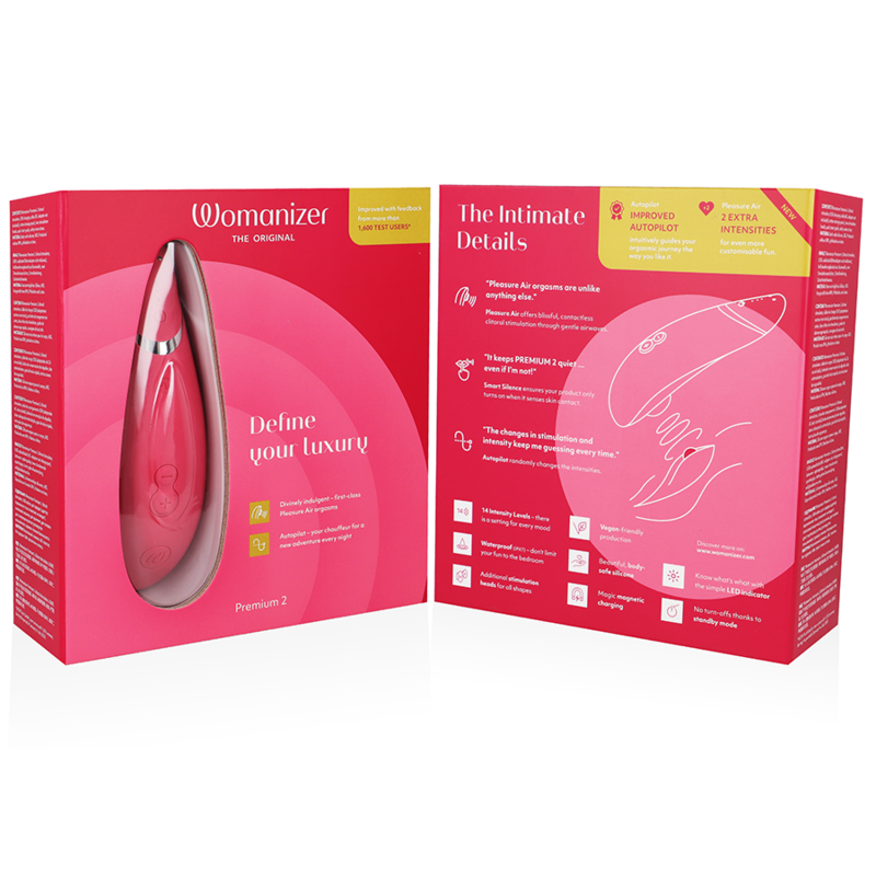 Raspberry-colored Womanizer Premium 2 clitoral stimulator with sleek, ergonomic design in open pink and yellow packaging.