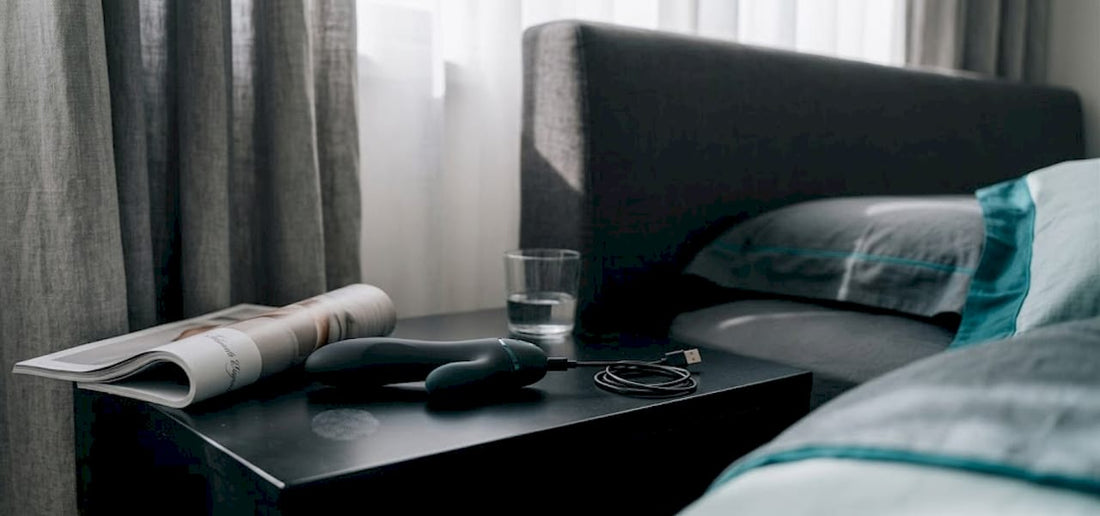 Rechargeable vibrator on nightstand with charging cable