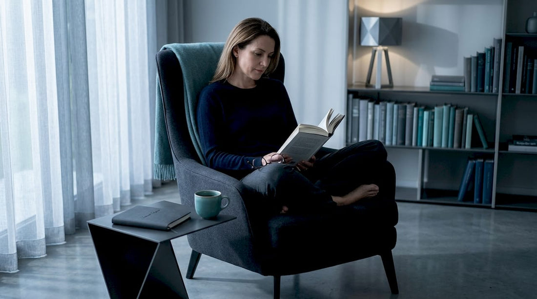 Woman reading book in calm living room