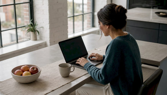 Woman discreetly shopping online at laptop