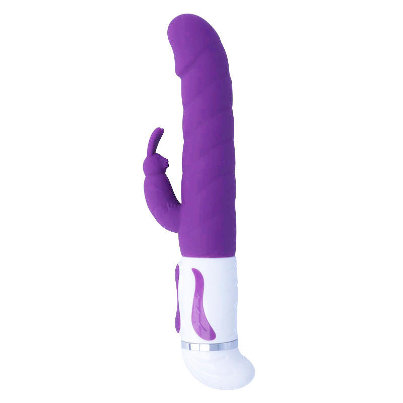 Lilac silicone vibrator with textured shaft and curved clitoral stimulator on white base.