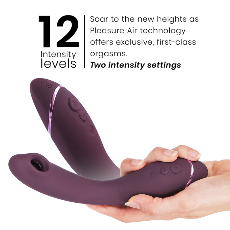 Aubergine-colored Womanizer OG G-Spot vibrator with curved design and control buttons held in hand.