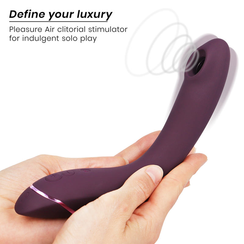 Curved aubergine-colored silicone clitoral stimulant with sleek ergonomic design held in hands.