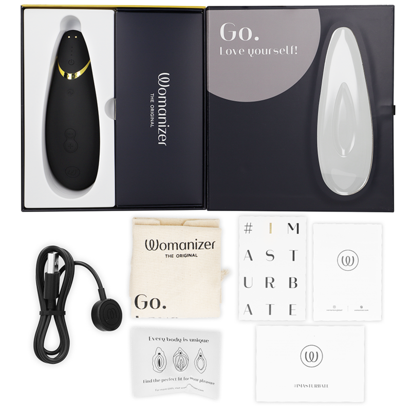 Black Womanizer Premium 2 clitoral stimulator with charging cable, storage pouch, and instruction manuals in open box.