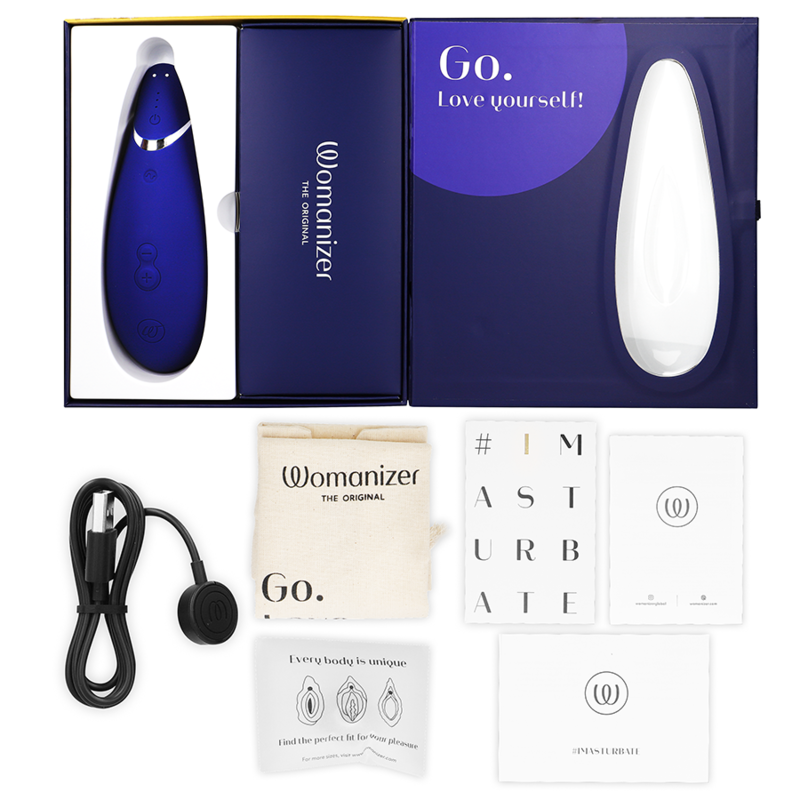 Blueberry-colored Womanizer Premium 2 clitoral stimulator with white silicone tip and rounded shape, accompanied by charging .