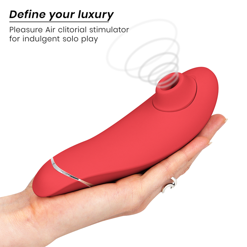 Raspberry-colored ergonomic clitoral stimulator with air pulse feature in hand.