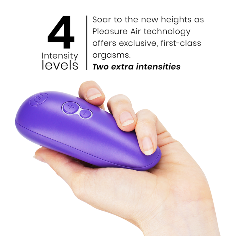 Hand holding compact indigo Womanizer Starlet 3 clitoral stimulator with three buttons on top.