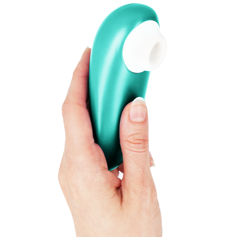 Turquoise curved clitoral stimulator with white silicone tip held in hand.