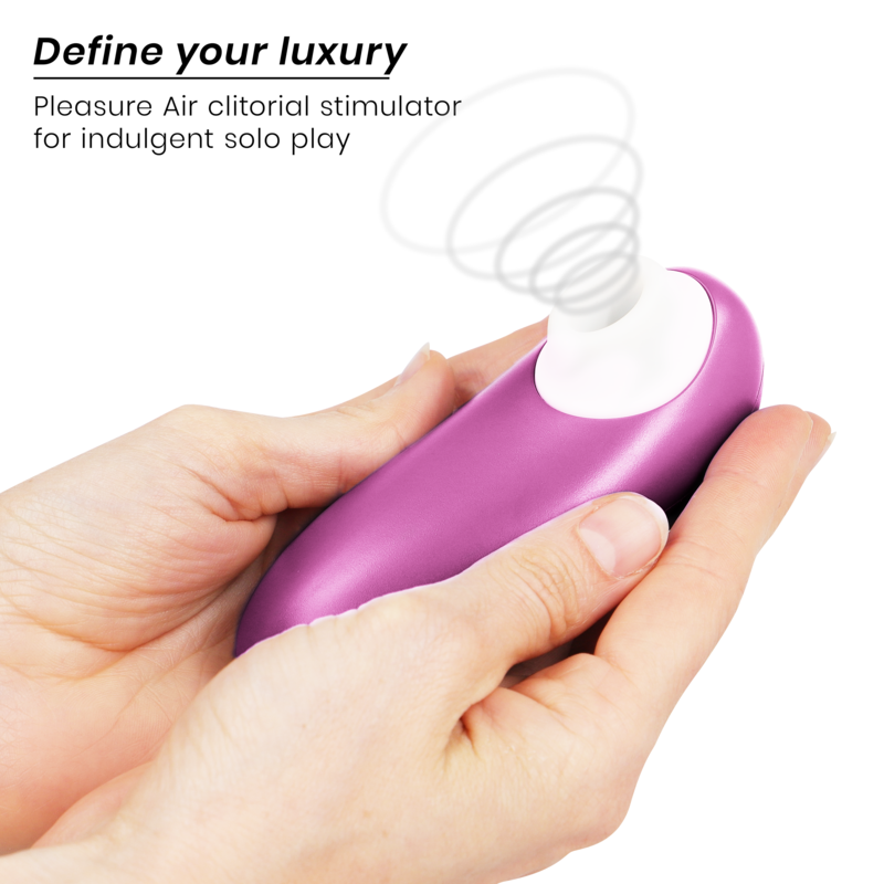 Compact violet Womanizer Starlet 3 clitoral stimulator with white air nozzle held in hands.