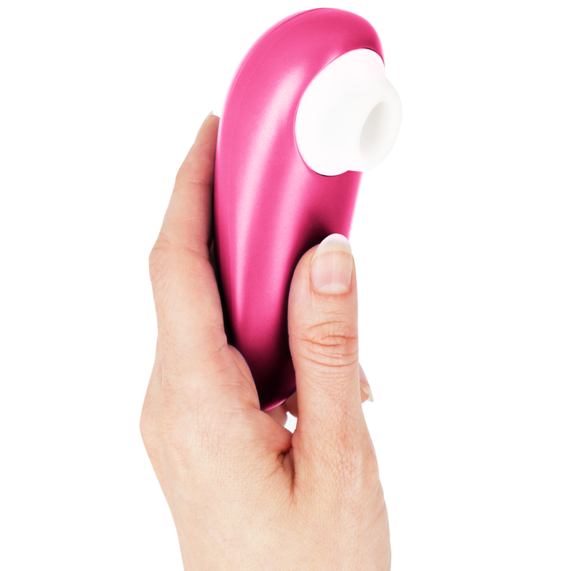 Pink Womanizer Starlet 3 clitoral stimulator held in hand with white silicone tip.