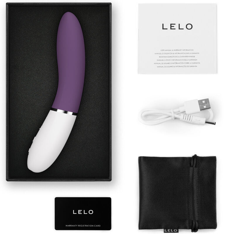 Violet and white curved G-spot stimulator with silver accent, USB charging cable, black storage pouch, and instruction.
