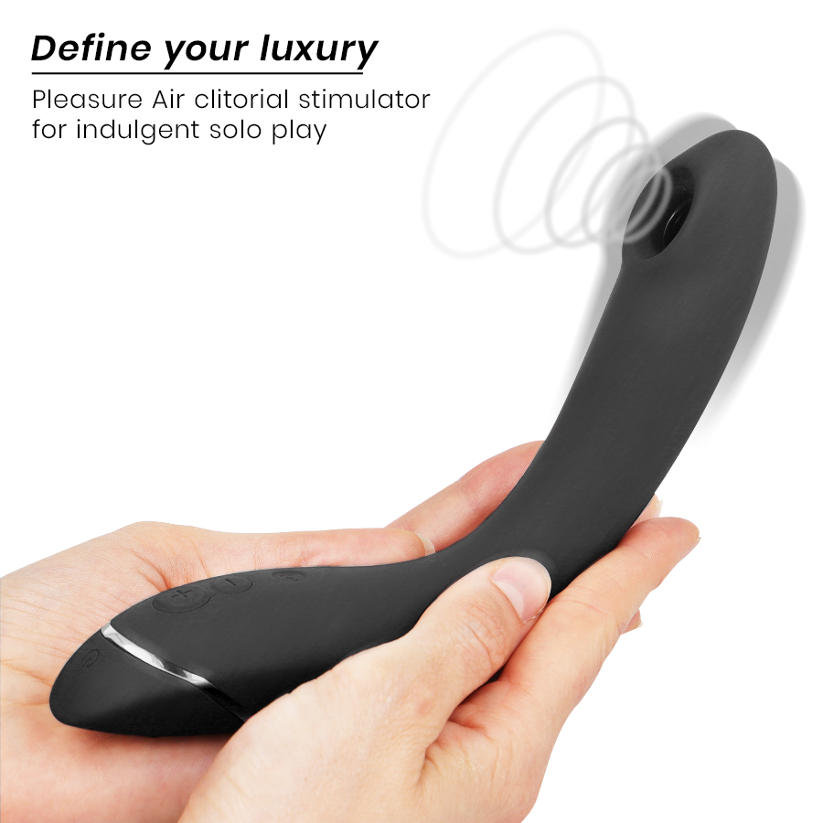 Sleek black curved personal air pulse stimulator with silver accent, held in hands.