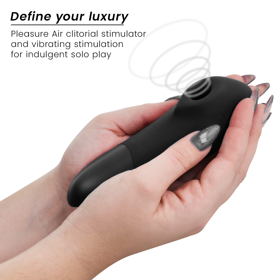 Black sleek Womanizer Enhance clitoral stimulator held in hands with metallic silver nails.