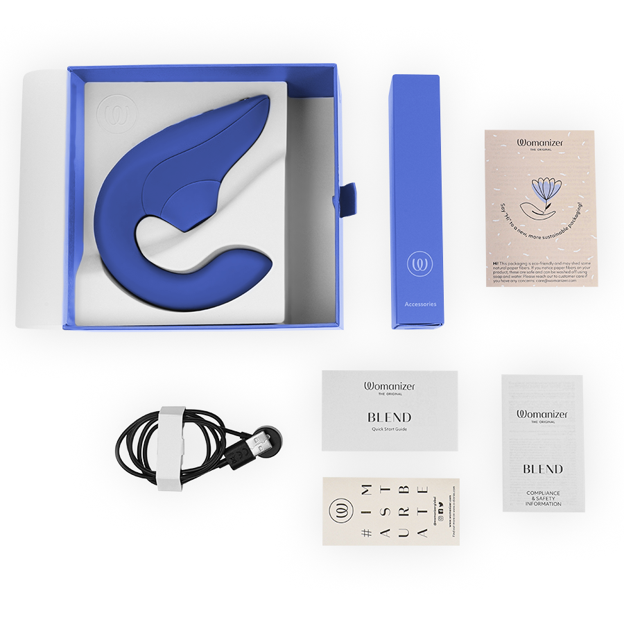 Vibrant blue curved rabbit vibrator stimulator with matching blue box, USB charging cable, and user manuals laid out on.