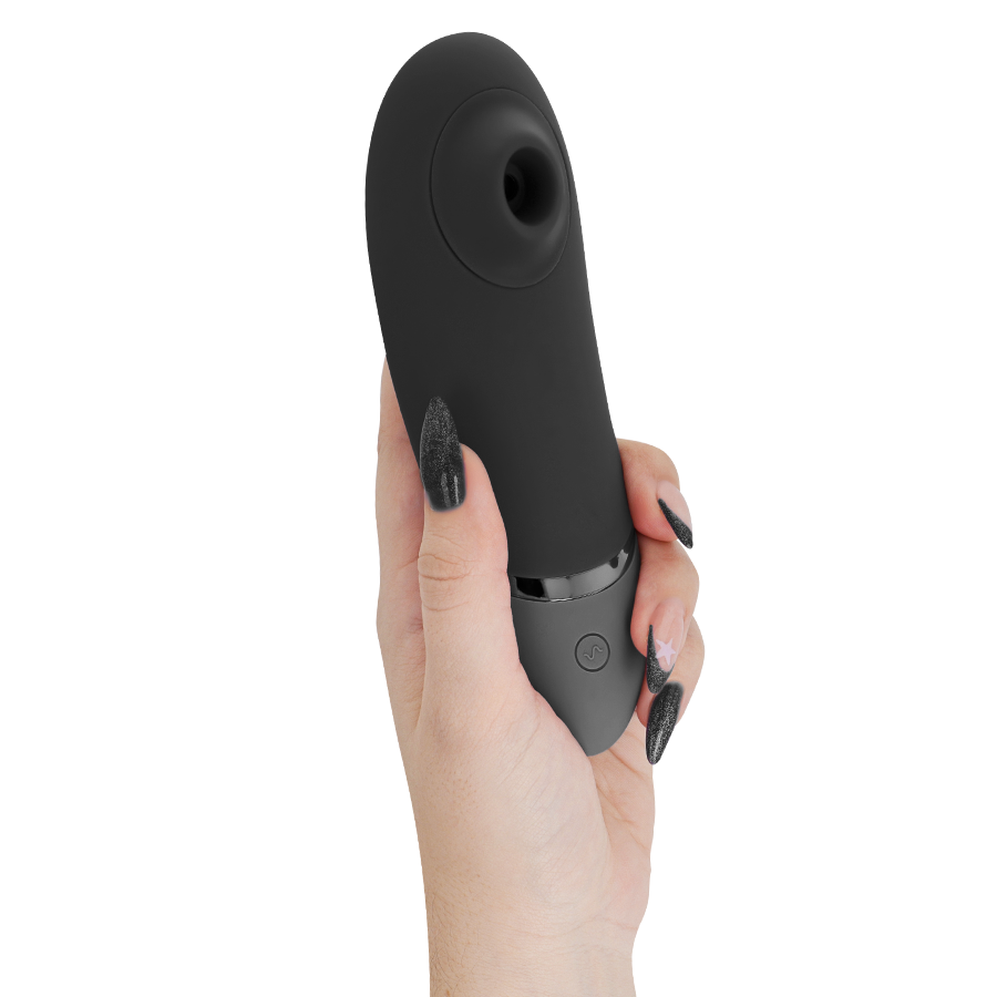 Black Womanizer NEXT clitoral stimulator with silicone head and single-button control held in hand.