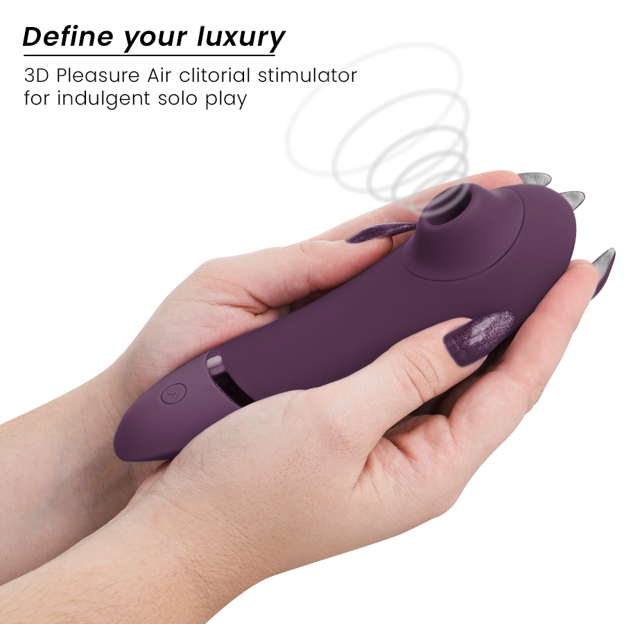 Dark purple Womanizer Next clitoral stimulator with ergonomic shape held in hands.