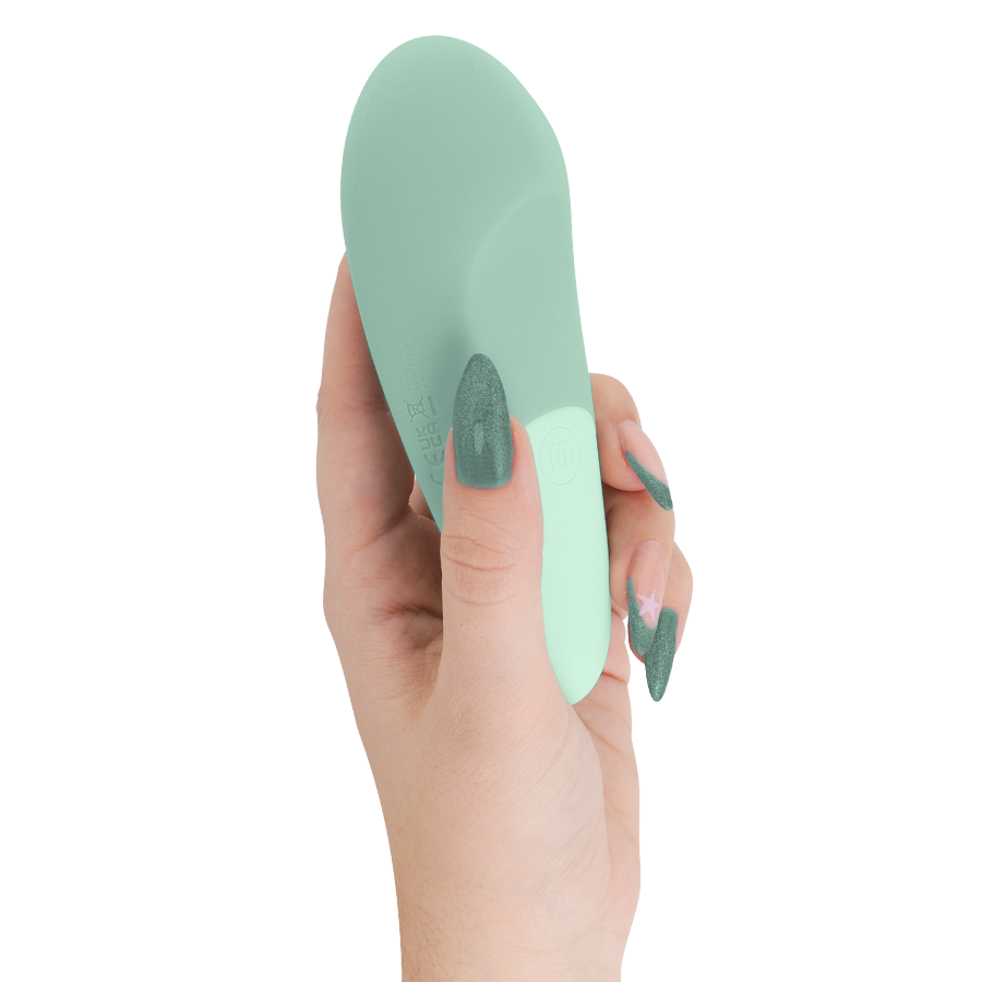 Sage green ergonomic silent vibrator held in hand with matching sage green nails.