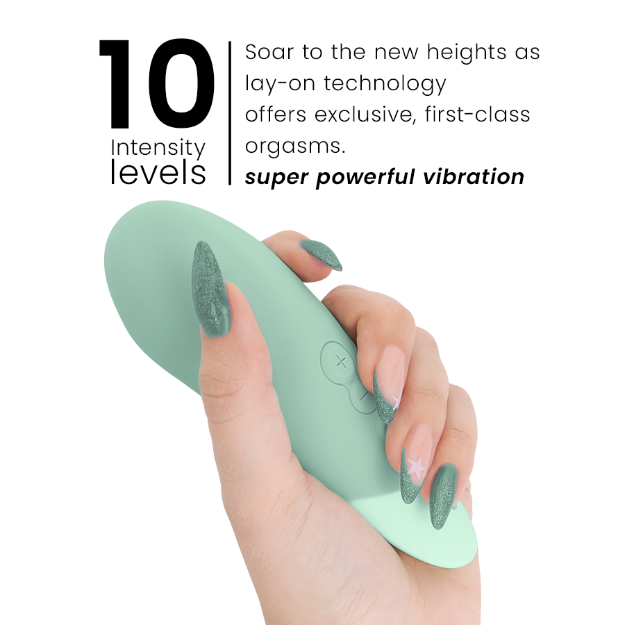 Sage green ergonomic vibrator with smooth silicone surface held in hand with matching green nails.