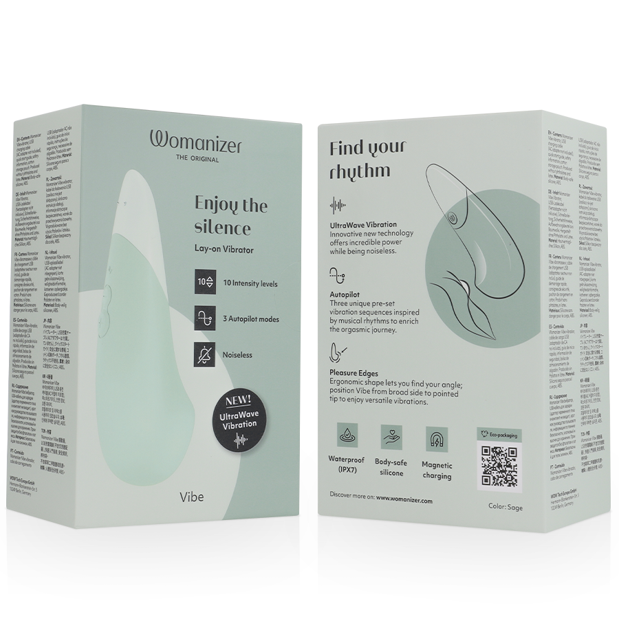 White Womanizer Vibe Lay-On Silent Vibrator with sage green accents displayed next to its minimalist sage-themed packaging.