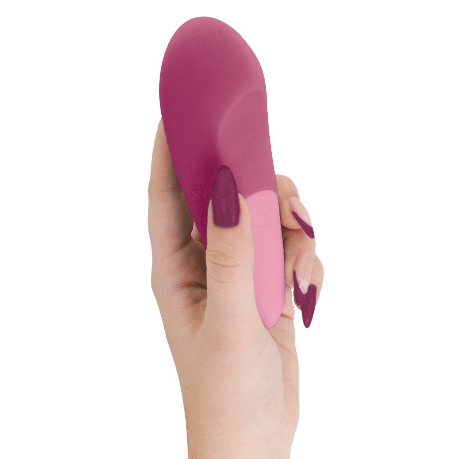 Dusky pink silicone silent vibrator with ergonomic curved shape held in hand.
