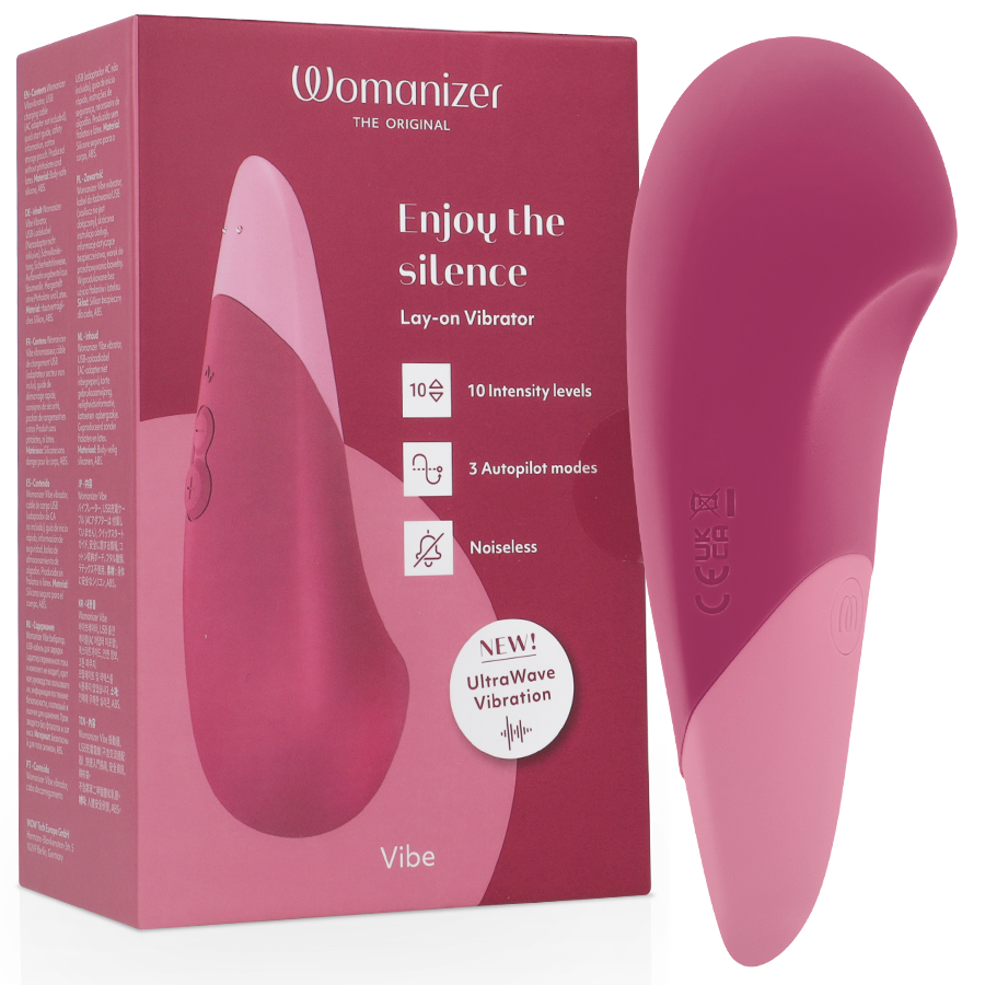 Dusky pink Womanizer Vibe lay-on silent vibrator with smooth curved design next to matching box.