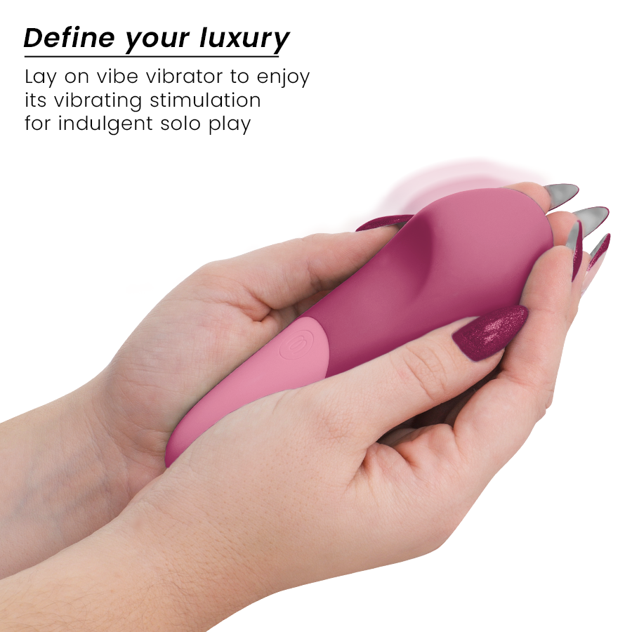 Dusky pink silicone vibing lay-on vibrator held in both hands with matching nail polish.