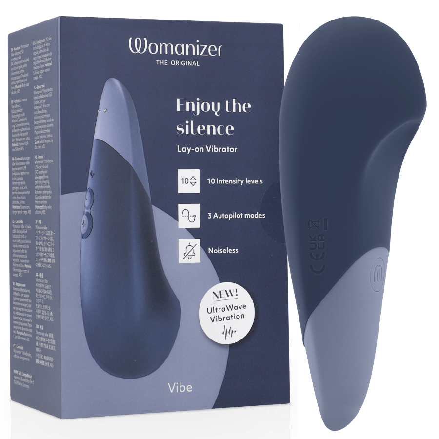 Dark blue Womanizer Vibe lay-on silent vibrator with curved ergonomic design next to matching product box.